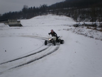 quad on snow drifting